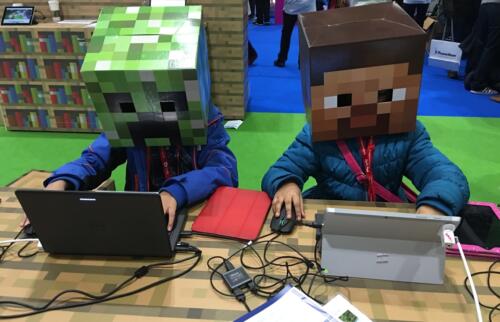 Two students build in Minecraft at BETT Conference